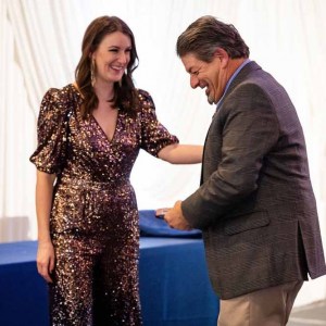 Laura-and-Jeff-laughing-with-trophy-on-stage